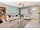 Bright living room with a ceiling fan and stylish furniture arranged on a decorative rug at 844 Rosalia Dr, Sanford, FL 32771