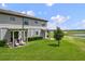 Spacious backyard with well-maintained lawn and pergola-covered seating area at 8549 Zoeller Hills Dr, Davenport, FL 33896