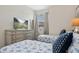 Bright bedroom with two twin beds, white linens with blue stars, a dresser and a TV at 8549 Zoeller Hills Dr, Davenport, FL 33896