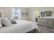 Relaxing bedroom featuring a comfortable queen bed, dresser, and serene decor at 8549 Zoeller Hills Dr, Davenport, FL 33896