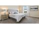 Cozy primary bedroom with plush carpet, comfortable bedding, and natural light at 8549 Zoeller Hills Dr, Davenport, FL 33896