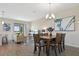 Bright dining area featuring a wooden table, seating for six and natural light at 8549 Zoeller Hills Dr, Davenport, FL 33896