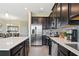 Modern kitchen with stainless steel appliances, tile backsplash, and a large island at 8549 Zoeller Hills Dr, Davenport, FL 33896