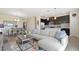 Open concept living room with sofa, dining area, and access to the kitchen at 8549 Zoeller Hills Dr, Davenport, FL 33896