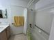 Bright bathroom featuring a shower-tub combo and tiled walls at 2524 Grassy Point Dr # 104, Lake Mary, FL 32746
