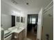 Clean bathroom with a single sink vanity, mirrored wall, and a shower with white tiles at 2524 Grassy Point Dr # 104, Lake Mary, FL 32746