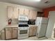 Kitchen with white appliances and cabinets, including a microwave, oven, and refrigerator at 2524 Grassy Point Dr # 104, Lake Mary, FL 32746