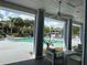 Community pool view from under the covered patio with seating and ceiling fans at 2524 Grassy Point Dr # 104, Lake Mary, FL 32746