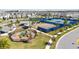 Aerial view of the community with a park including tennis court, basketball court, and playground at 10209 Folly Beach Rd, Orlando, FL 32827