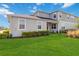 Well-maintained backyard and home exterior on a sunny day with a blue sky at 10209 Folly Beach Rd, Orlando, FL 32827