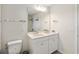 Bright bathroom features a double sink vanity with modern fixtures and a large mirror at 10209 Folly Beach Rd, Orlando, FL 32827