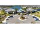 Aerial view showcasing the community clubhouse with a pool, ample parking, and lake views at 10209 Folly Beach Rd, Orlando, FL 32827