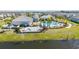 Aerial view of the community pool, clubhouse, splash pad, and palm trees at 10209 Folly Beach Rd, Orlando, FL 32827