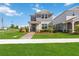 Charming two-story home featuring a quaint front porch and well-manicured lawn in a sidewalk neighborhood at 10209 Folly Beach Rd, Orlando, FL 32827