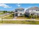 Charming two-story home with manicured lawn, shrubbery, and a paved walkway to the front entrance at 10209 Folly Beach Rd, Orlando, FL 32827
