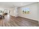 Bright hallway with wood floors, connecting the kitchen, living room, and staircase at 10209 Folly Beach Rd, Orlando, FL 32827