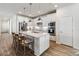 Spacious kitchen with island seating, modern lighting, and stainless steel appliances at 10209 Folly Beach Rd, Orlando, FL 32827