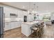 Modern kitchen with white cabinets, island with seating, and stainless steel appliances at 10209 Folly Beach Rd, Orlando, FL 32827