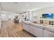 Open-concept living room with wood floors and easy access to the modern kitchen at 10209 Folly Beach Rd, Orlando, FL 32827
