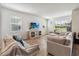 Bright living room features wood floors, comfortable seating, and a large TV at 10209 Folly Beach Rd, Orlando, FL 32827