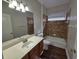 Bathroom featuring a single sink vanity and a shower and tub combo at 110 Sophia Marie Cv, Sanford, FL 32771