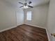 Bedroom with ceiling fan, wood floors, and closet space at 110 Sophia Marie Cv, Sanford, FL 32771