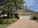 Charming home features a brick-paved driveway and well-manicured landscaping at 110 Sophia Marie Cv, Sanford, FL 32771