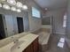 Large bathroom featuring a soaking tub, shower, and double sink vanity at 110 Sophia Marie Cv, Sanford, FL 32771