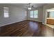 A bright main bedroom with an ensuite bathroom and wood flooring at 110 Sophia Marie Cv, Sanford, FL 32771