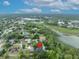 An aerial view of a property in relation to a lake and green spaces at 1130 Roxboro Rd, Longwood, FL 32750