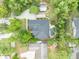 Aerial view of a home with a private backyard oasis featuring a unique lagoon-style pool and lush landscaping at 1130 Roxboro Rd, Longwood, FL 32750