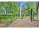 Backyard firepit patio with seating and a swing set at 1130 Roxboro Rd, Longwood, FL 32750
