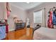 Bright bedroom with shiny wood floors, complemented by neutral walls and natural light at 1130 Roxboro Rd, Longwood, FL 32750