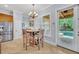 Eat-in kitchen features a round breakfast table near the door to the outdoor lanai and pool at 1130 Roxboro Rd, Longwood, FL 32750
