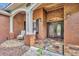 Elegant home entrance with stone flooring, double doors, and charming brick facade at 1130 Roxboro Rd, Longwood, FL 32750