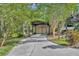 Detached garage with a carport for boat parking on long concrete driveway at 1130 Roxboro Rd, Longwood, FL 32750