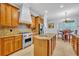 Gourmet eat-in kitchen boasts stainless steel appliances, a large island, and custom cabinetry at 1130 Roxboro Rd, Longwood, FL 32750
