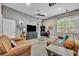Recreation room featuring comfortable leather couches, large TV, and block wall decor at 1130 Roxboro Rd, Longwood, FL 32750