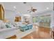 Open-concept living area with hardwood floors, a cozy sofa, and a view of the outdoor patio at 1130 Roxboro Rd, Longwood, FL 32750