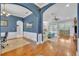 Inviting living space with hardwood floors, arched doorways, and abundant natural light at 1130 Roxboro Rd, Longwood, FL 32750