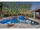 Backyard pool with stone waterfall and lush plantings around the pool at 1130 Roxboro Rd, Longwood, FL 32750