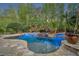 Tranquil pool area with spa and rock features, illuminated for evening enjoyment at 1130 Roxboro Rd, Longwood, FL 32750