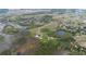 Wide aerial view of a neighborhood with trees, bodies of water, and several properties at 11320 Montevista Rd, Clermont, FL 34711