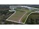 Expansive property featuring a cleared pasture area, trees, and several ponds at 11320 Montevista Rd, Clermont, FL 34711