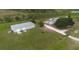 Wide angle aerial view of property with main house and outbuilding, surrounded by vast fields and distant trees at 11320 Montevista Rd, Clermont, FL 34711