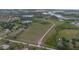 Aerial view of sprawling acreage featuring ponds, trees, and a long driveway at 11320 Montevista Rd, Clermont, FL 34711