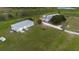 Sprawling property featuring a metal outbuilding and in-ground pool, all set against a backdrop of lush greenery at 11320 Montevista Rd, Clermont, FL 34711