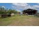 Ground level shot of the barn and old equipment at 11320 Montevista Rd, Clermont, FL 34711