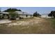 Side yard and metal building of a tan single story home with metal roof at 11320 Montevista Rd, Clermont, FL 34711