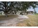 Charming country house with a spacious porch, complemented by a mature tree and a private drive at 11320 Montevista Rd, Clermont, FL 34711